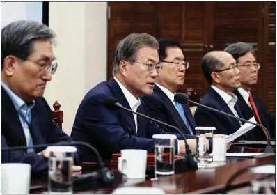  ?? AP/Yonhap/BEE JAE-MAN ?? South Korean President Moon Jae-in (second from left) speaks Monday in Seoul about the trade dispute, urging Japan to lift its tightened controls on high-tech exports to South Korea.