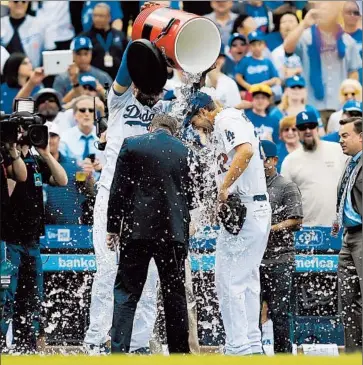  ?? Luis Sinco Los Angeles Times ?? A SHUTOUT of Giants earned Clayton Kershaw a cold shower from Matt Kemp. An interviewe­r got wet too.