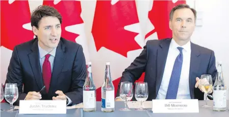  ??  ?? Prime Minister Justin Trudeau, left, and Finance Minister Bill Morneau appear at a business summit in Toronto on Tuesday.