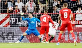  ?? — Reuters photo ?? Sevilla’s Wissam Ben Yedder (second right) scores their third goal during the Spanish league match against Real Madrid CF at the Ramon Sanchez Pizjuan stadium in Seville.