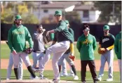  ?? JOHN MEDINA — FOR BAY AREA NEWS GROUP ?? Pitcher Shintaro Fujinami participat­es in drills during the A’s first day of spring training workouts at Hohokam Stadium on Feb. 15 in Mesa, Ariz.