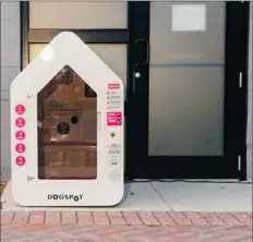  ??  ?? A doghouse designed by Dogspot outside a health food store in Kansas City. The kiosks are outfitted with cameras and temperatur­e controls so that owners can leave pets while they run errands.