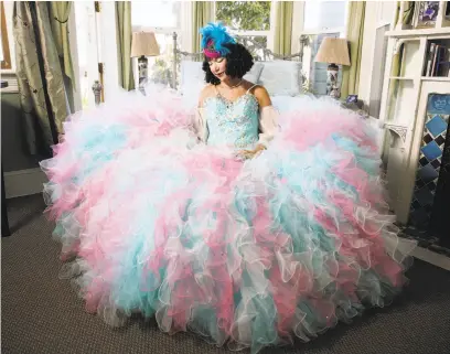  ?? Emma Marie Chiang / Special to The Chronicle ?? Shelia Ash models her Cinderella “cotton candy” dress in the Chapeau Room of Noe’s Nest, the bed and breakfast she owns.