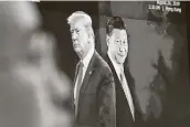  ?? Associated Press file photo ?? Images of President Donald Trump and Chinese President Xi Jinping appear on a computer screen in Seoul, South Korea. Chinese tariff cuts begin Jan. 1.