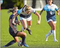  ?? SEAN D. ELLIOT/ THE DAY ?? Connecticu­t College’s Marielle McEnaney goes airborne from a collision with Trinity’s Delaney Markham (27) in NESCAC women’s soccer action Tuesday on Freeman Field in New London. Trinity won 4-3 in double overtime.