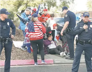  ?? — AFP photo ?? Pro-wall demonstrat­or Melinda Oporto lies on the ground after collapsing at a rally in front of the San Ysidro Border Patrol Station in San Ysidro, California.