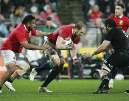  ??  ?? WELLINGTON: Lions second rower Alun Wyn Jones runs at New Zealand second row forward Sam Whitelock during the second rugby test between the British and Irish Lions and the All Blacks in Wellington, New Zealand, Saturday.—AP