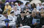  ?? JACOB KING — PA VIA AP ?? Veterans sing Sunday as they watch the official opening of the British Normandy Memorial in France via a live feed, during a ceremony at the National Memorial Arboretum in Alrewas, England.