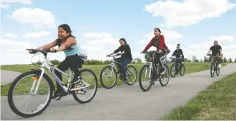  ??  ?? The Warrens are using their unexpected downtime during the pandemic to try new activities, including going on daily bike rides down by the river near the Chief Mistawasis Bridge.