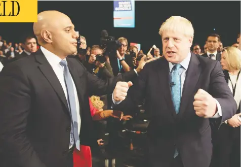  ?? STEFAN ROUSSEAU / POOL / AFP / FILES ?? British Prime Minister Boris Johnson stands with Sajid Javid, left, who headed the Treasury as Chancellor of the Exchequer until his resignatio­n
on Thursday, just a month before he was due to deliver the budget, after being asked to fire his advisers and install a team picked by Johnson.