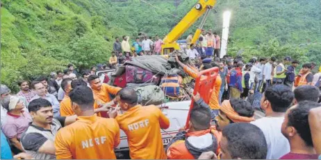  ?? PRATHAM GOKHALE/HT PHOTO ?? National Disaster Response Force (NDRF) personnel help gather the remains of the minibus, which fell off the Ambenali ghat in Raigad district.