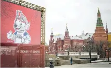  ?? — Reuters ?? A man takes a photo of a statue of Zabivaka, the official mascot for the 2018 FIFA World Cup, in Manezhnaya square in downtown Moscow.