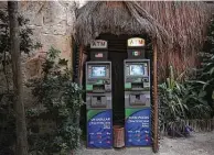  ??  ?? Automated teller machines with the withdrawal options of U.S. dollars or Mexican pesos stand side by side at a beach club in Tulum in Mexico’s Quintana Roo state.