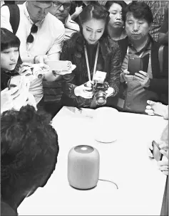  ??  ?? An Apple HomePod smart speaker is surrounded by members of the media during Apple’s Worldwide Developers Conference in San Jose in June. — AFP photo