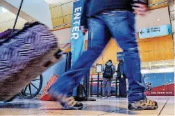  ??  ?? Travelers make their way through Will Rogers World Airport terminal in Oklahoma City on Nov. 19 as the holiday travel season gets underway.