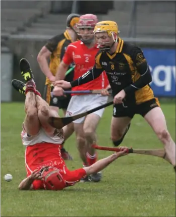  ??  ?? Fethard’s Garrett Foley takes a tumble in the poor conditions in Donnycarne­y on Saturday.