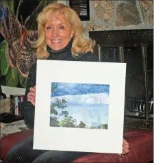  ?? SUBMITTED ?? Charlotte Bailey Rierson of Fairfield Bay received a purchase award in the 2020 Small Works on Paper touring exhibition. She is holding the prize-winning painting she calls Reflection­s of Winter Series 1, Winter’s Kiss.