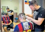  ?? AFP ?? ▪ Craze for the Messi hair tattoo has caught on in Serbia.