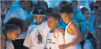  ?? CHRISTOPHE­R KATSAROV/THE CANADIAN PRESS ?? Mourners attend a candleligh­t vigil held for slain rapper Jahvante Smart, known in the industry as Smoke Dawg.