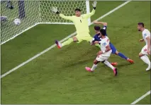  ?? ?? Christian Pulisic of the United States scores his side’s opening goal during the World Cup group B soccer match between Iran and the United States on Tuesday.