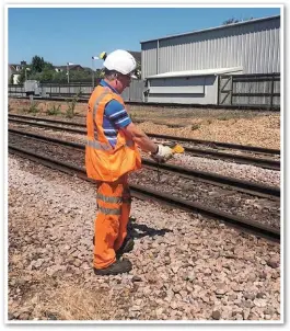  ?? NETWORK RAIL. ?? A Network Rail trackworke­r monitors the tracks on June 26, when temperatur­es soared to as high as 30°C across much of the UK.