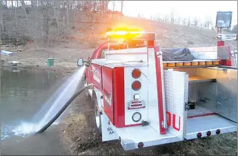  ?? PHOTO SUBMITTED ?? Firefighte­rs have draft tested and hydro tested a rebuilt Squad 1 truck, which has a 300-gallon water tank and 100 feet of 1-inch booster line. The truck, when complete, will house rescue equipment and help firemen when they are on a call for a car...