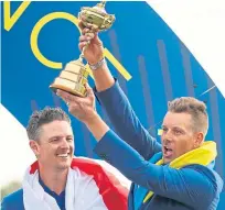  ?? Picture: Getty. ?? Henrik Stenson lifts the Ryder Cup alongside Europe team-mate Justin Rose.