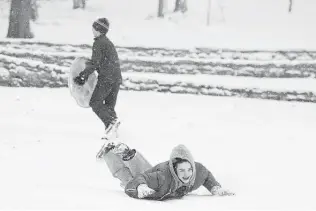  ?? George Walker IV /The Tennessean via AP ?? Clyde Vaughn enjoys sledding at a park Thursday in Nashville, Tenn., as a winter storm prompted schools to close. Roads are expected to become even more treacherou­s as they freeze overnight.