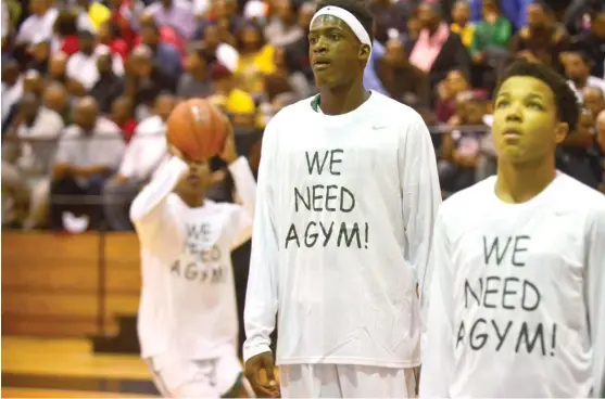  ?? | PATRICK GLEASON/FOR THE SUN-TIMES ?? Morgan Park basketball players sport their “We Need a Gym” warm-up shirts. The gym at Morgan Park only can seat about 200 fans.