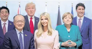  ??  ?? From left, Japan’s Prime Minister Shinzo Abe, World Bank Group President Jim Yong Kim, US President Donald Trump, Ivanka Trump, German Chancellor Angela Merkel and Canada’s Prime Minister Justin Trudeau at the G20 summit on Saturday.