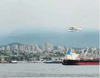  ?? NICK PROCAYLO ?? Hazy conditions over the North Shore mountains as Environmen­t Canada issued an air quality advisory due to winds carrying smoke from wildfires burning in B.C.’s Interior to the province’s south coast.