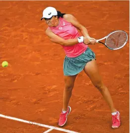  ?? AFP ?? Poland’s Iga Swiatek returns the ball to Sweden’s Rebecca Peterson during their women’s singles match of the French Open tennis tournament at the Roland Garros in Paris on Thursday. Swiatek won 6-1, 6-1. —