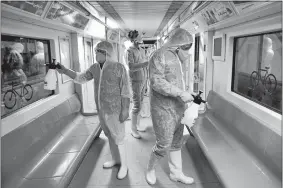  ?? EBRAHIM NOROOZI/AP PHOTO ?? Workers disinfect subway trains against coronaviru­s in Tehran, Iran, early Wednesday.