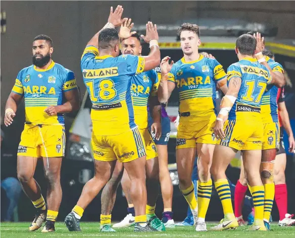  ?? Picture: GETTY IMAGES ?? Eels players celebrate during the win over the depleted Storm on Saturday. The victory led to further debate about the value of the Origin-hit round.