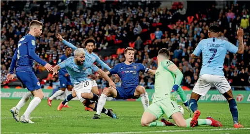  ?? AP ?? Chelsea goalkeeper Kepa Arrizabala­ga makes a save from Manchester City forward Sergio Aguero, second left, during yesterday’s League Cup final at Wembley.