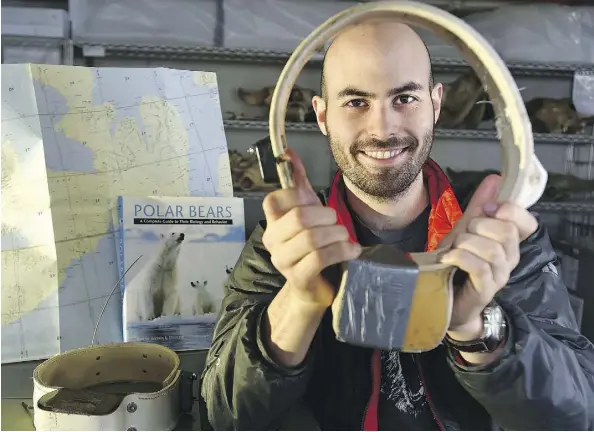  ?? ED KAISER ?? University of Alberta research assistant Ron Togunov holds a GPS radio collar designed for polar bears. Togunov is a member of a research team that is studying how polar bears use a technique called crosswinds search to hunt for their prey — ringed...