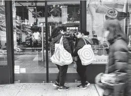  ?? Spencer Platt / Getty Images ?? Shoppers enter a store in Manhattan last week in New York City. As Americans begin their holiday shopping early this year in an effort to avoid shortages of some goods, U.S. retail sales surged 1.7% last month, the largest gain since March.