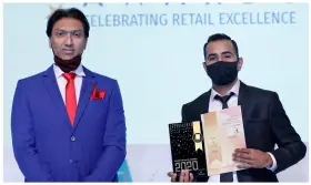  ??  ?? Most Admired STORE MANAGER of the Year Nimish Makvana (presenter) with Noman Khan