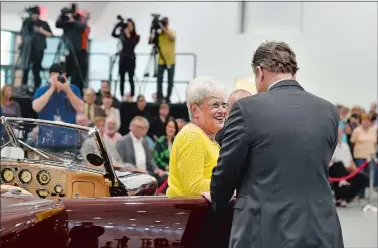  ?? TIM MARTIN/THE DAY ?? Lt. Gov. Nancy Wyman is assisted out of a 1937 Cord Model 812 Supercharg­ed “Sportsman” by Kevin Brown, chairman of the Mohegan Tribe, at the ribbon-cutting ceremony for the Mohegan Sun Earth Expo and Convention Center.