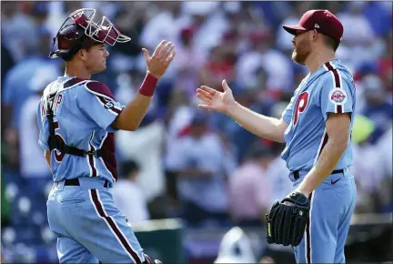  ?? RICH SCHULTZ — THE ASSOCIATED PRESS ?? Philadelph­ia Phillies catcher Andrew Knapp (5) and closer Ian Kennedy (31) shake hands after the final out of the ninth inning of a baseball game against the Dodgers, Thursday in Philadelph­ia. The Phillies defeated the Dodgers 2-1.
