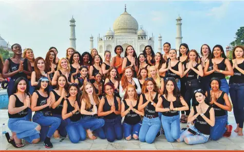  ?? PTI ?? Models participat­ing in an internatio­nal beauty pageant pose for photos in front of the Taj Mahal yesterday. More than 4o models from across the world have arrived in Agra, Uttar Pradesh, to get a glimpse of the marble wonder.