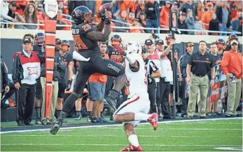  ?? ROB FERGUSON, USA TODAY SPORTS ?? Oklahoma State’s James Washington has had consecutiv­e seasons with 10 touchdown catches.