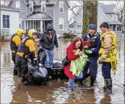  ?? BECKY MALEWITZ / SOUTH BEND TRIBUNE ?? Emergency workers use a boat Wednesday to help evacuate a northern Indiana resident amid flooding from melting snow and rain. Weather is blamed for hundreds of crashes and several fatalities.