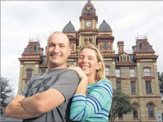  ?? Aaron Mason and his fiancee, Anne Cornell, stand in front of the Caldwell County Courthouse in Lockhart on Saturday. The two have visited every county courthouse in the state and have documented their trips on their Texas Courthouse Tour blog. They also a ??