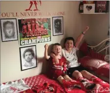  ??  ?? Conor and Seán McSweeney from Ballydaly, Millstreet celebratin­g a historic day for their beloved Liverpool FC.