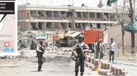  ?? — Reuters photo ?? Afghan officials inspect outside the German embassy in Kabul after the massive explosion.