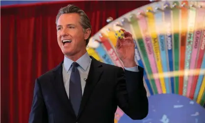  ?? Photograph: Paul Kitagaki Jr/Zuma Wire/Rex/Shuttersto­ck ?? California governor Gavin Newsom holds a lottery ball selected for the first of 15 California­ns to be awarded $50,000 for doing their part in getting vaccinated against Covid-19.