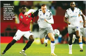  ??  ?? TUSSLE: Colchester’s Luke Norris, right, and Manchester, United’s Axel Tuanzebe battle for the ball