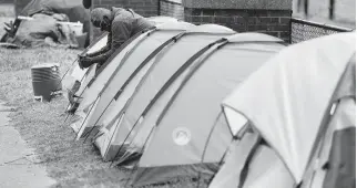  ?? STEPHEN M. KATZ/STAFF ?? The camp along Norfolk’s 19th Street, which started in November, is a visible sign of a huge increase in homelessne­ss during the pandemic.