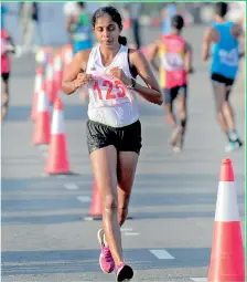  ??  ?? Niroshan Appuhamy (42) and Kalhari Madurika (125) leading the way at the Men's and Women's Race Walking event - Pix by Amila Gamage